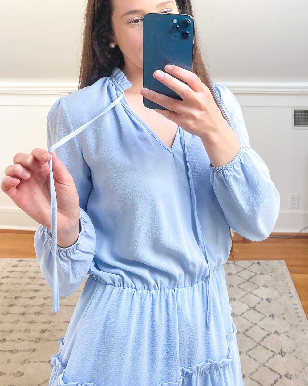 Affordable fashion blogger Stephanie Ziajka shows the neck detail of her Amazon blue chiffon ruffle dress on Diary of a Debutante