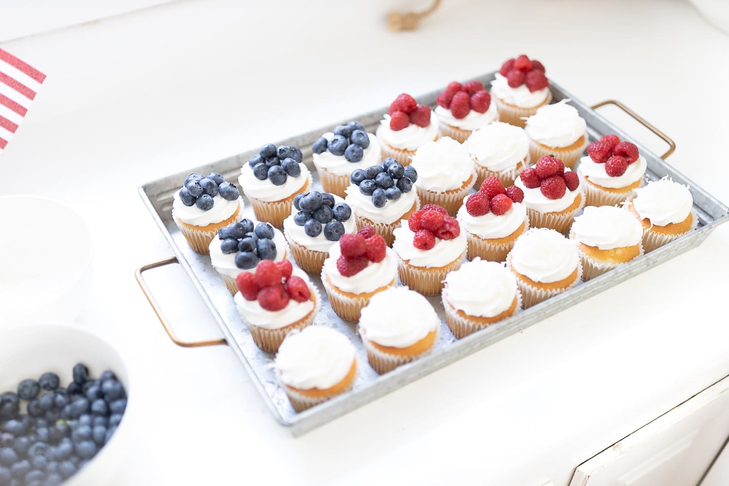 American flag dessert tray created with plain vanilla cupcakes and red, white, and blue fruit by entertaining blogger Stephanie Ziajka on Diary of a Debutante