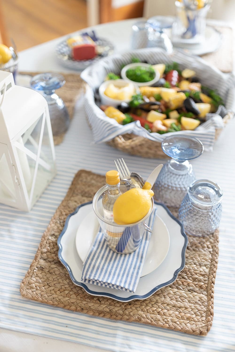 Blogger Stephanie Ziajka uses jute placemats, navy scalloped charger plates, and blue striped napkins to create festive clambake table settings on Diary of a Debutante Blogger Stephanie Ziajka uses jute placemats, navy scalloped charger plates, and blue striped napkins to create festive clambake table settings on Diary of a Debutante