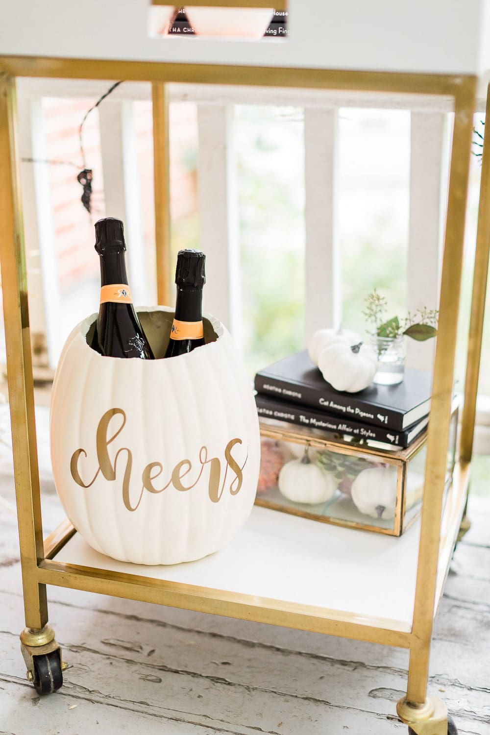 DIY Halloween ice bucket created with a white foam pumpkin, Cricut Explore Air 2, and permanent gold vinyl by DIY blogger Stephanie Ziajka on Diary of a Debutante