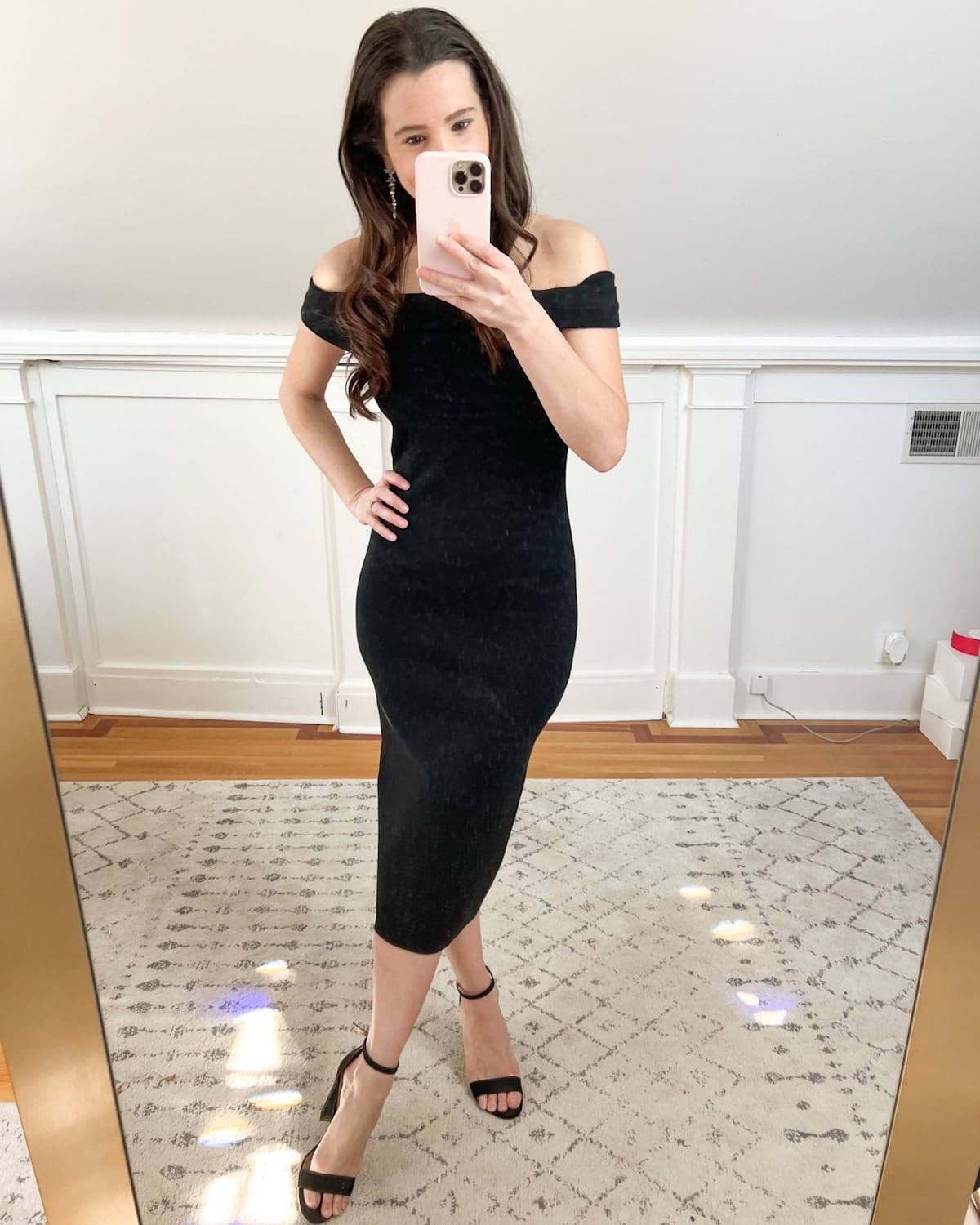 Affordable fashion blogger Stephanie Ziajka styles one of her favorite black classy christmas party dresses from Amazon with black block heel sandals and Kendra Scott Madelyn statement earrings on Diary of a Debutante