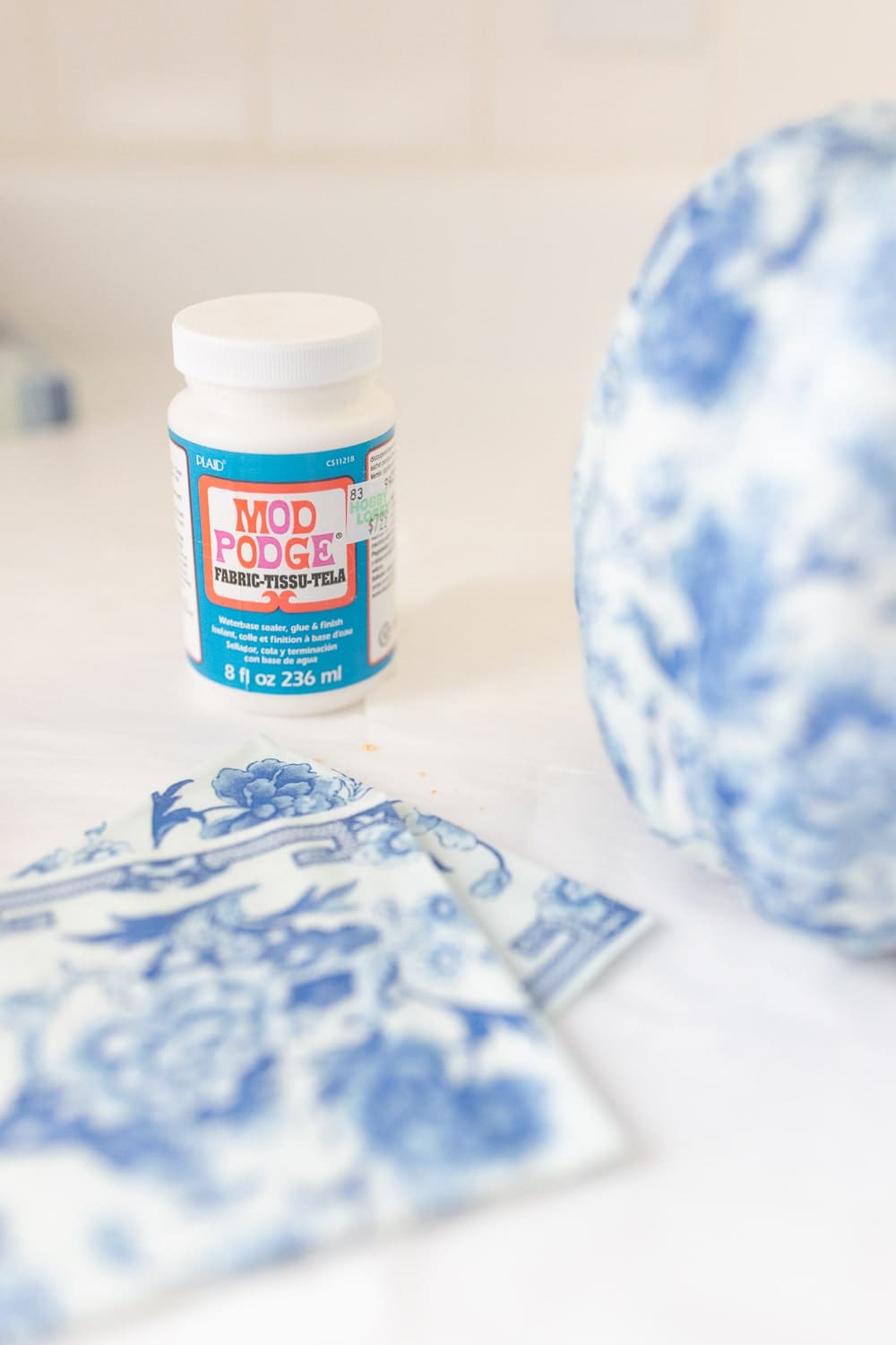 Blogger Stephanie Ziajka uses fabric Modge Podge for a napkin decoupage project on Diary of a Debutante